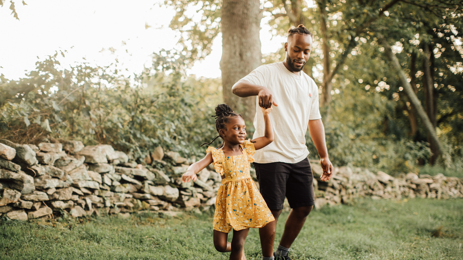 Adoptive dad playing with his daughter in a Birmingham park