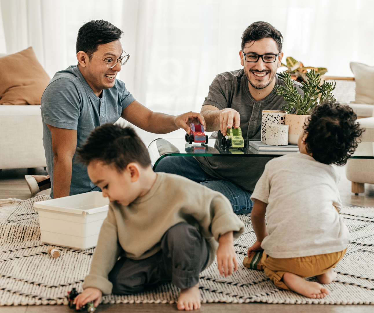 Adoptive parents playing with two toddlers